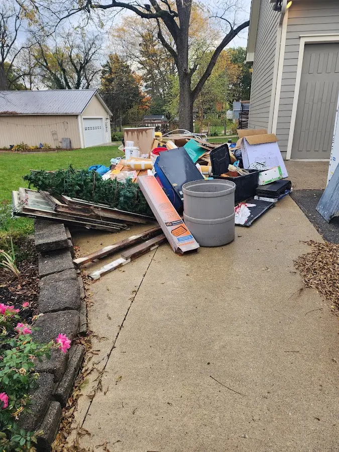 Dumpster being loaded with debris for Roofing Dumpster Rental in Trumann